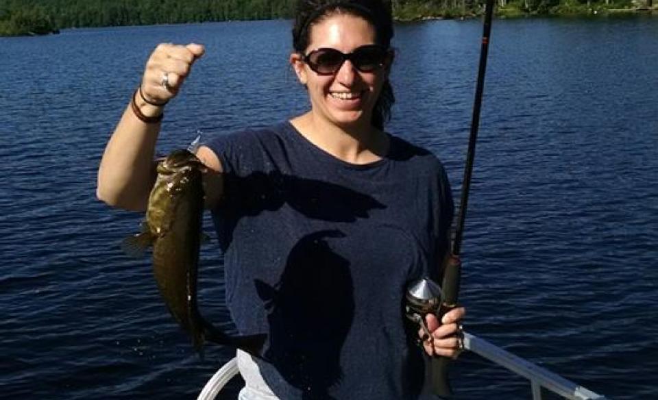 Woman holds her catch up for the camera