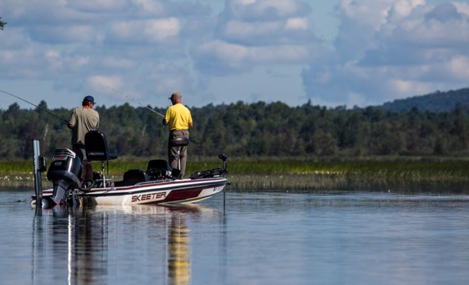 Two guys on a fishing boat on a beautiful day