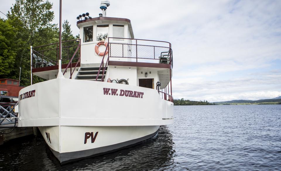 the WW Durant cruise boat on the water docked by the shore