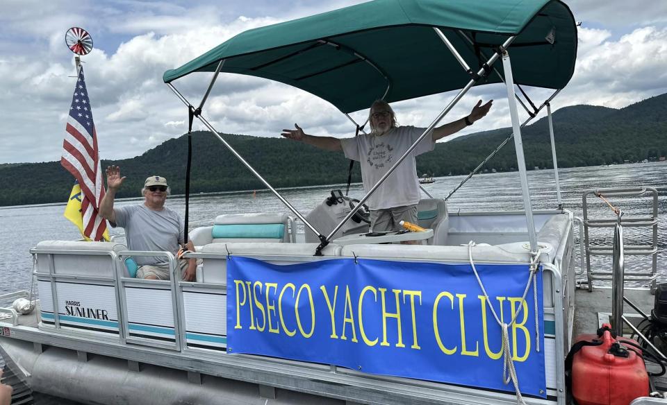 a pontoon boat with two men on board
