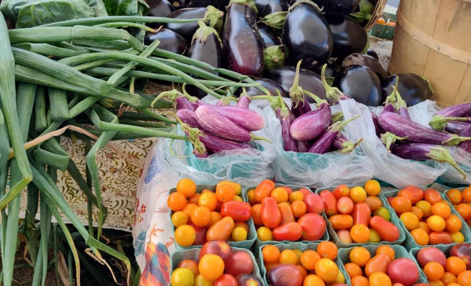 Photo of a variety of vegetables for sale at a farmers market.