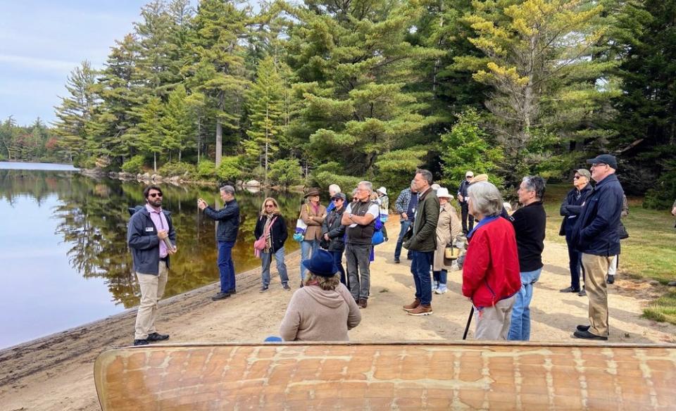 People on the shore listening to the historian.
