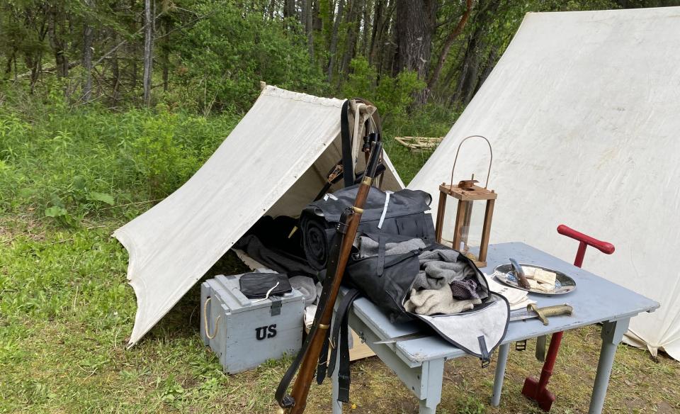 a photo of a canvas tent with related articles used during that time period on display