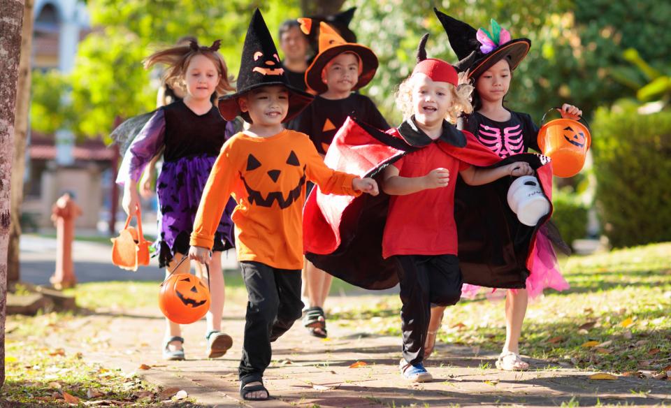 A group of kids dressed up trick or treating