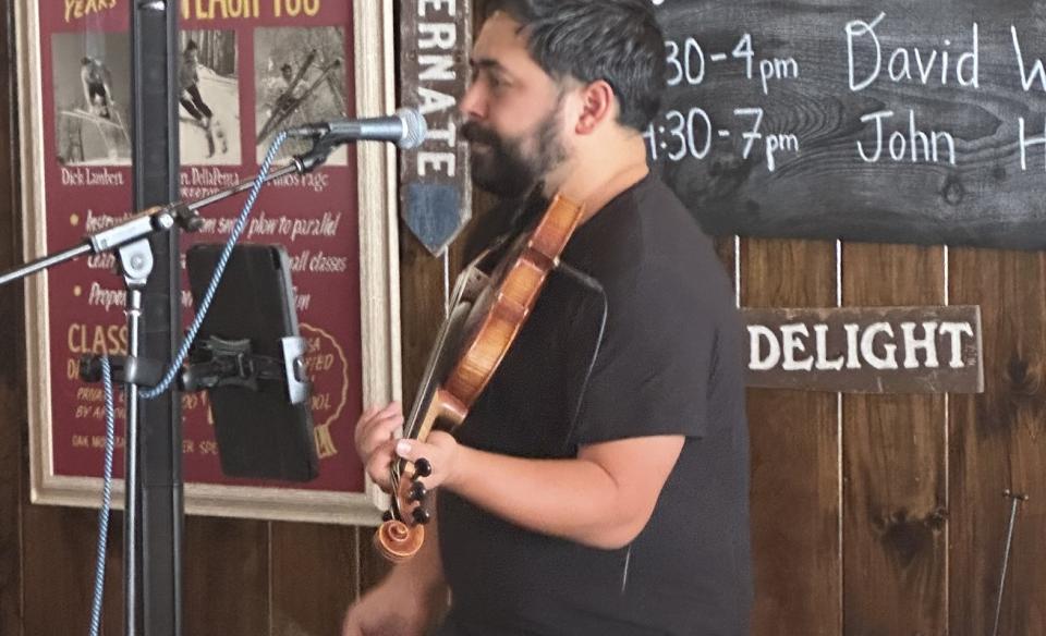 A photo of David playing his violin at Oak Mountian