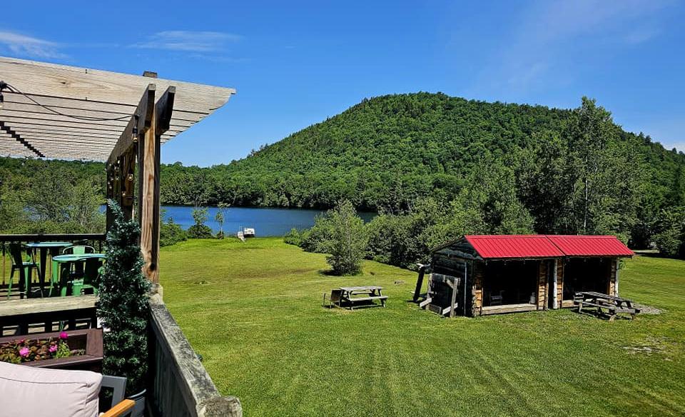 Lakeside view from a deck with a pergola