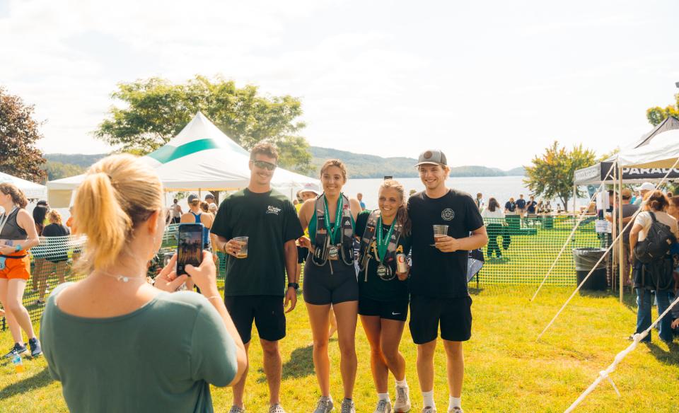 volunteers and participants gather around tables with fruit and snacks at the Adirondack Marathon.