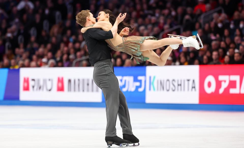 a woman in a red dress and a man in a blue suit