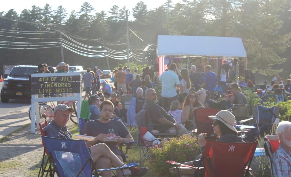 and relaxing on the beach near a building.