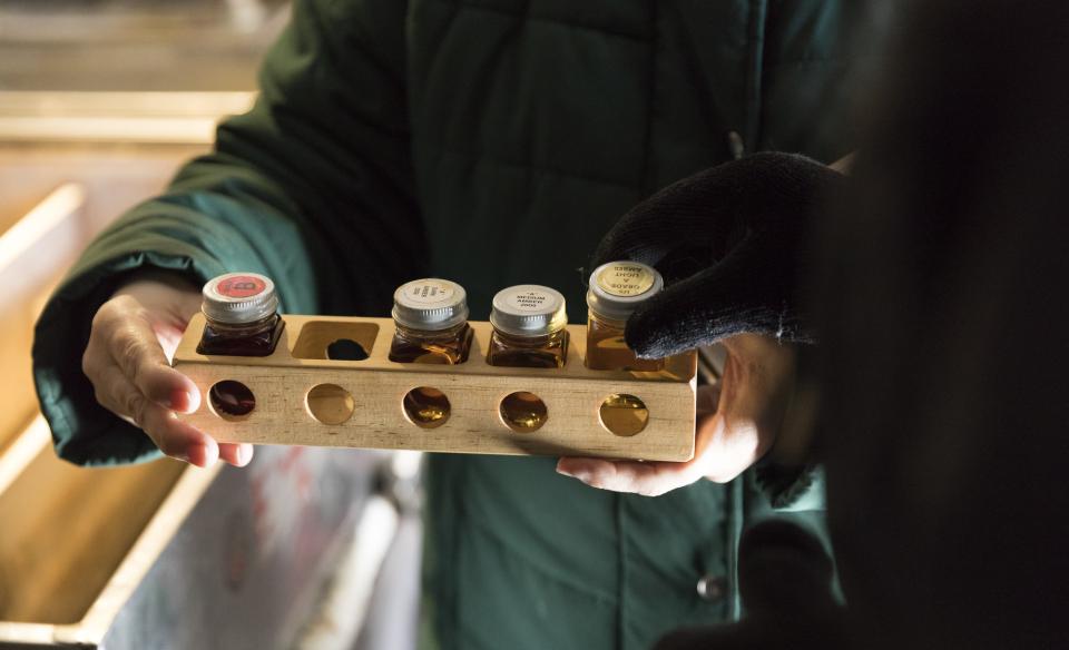 Jars of maple syrup of varying grades.