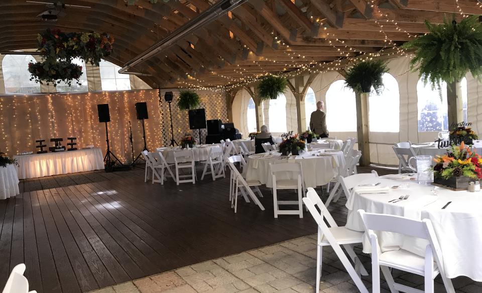 The large tent set up in the lawn with mobile dance floor