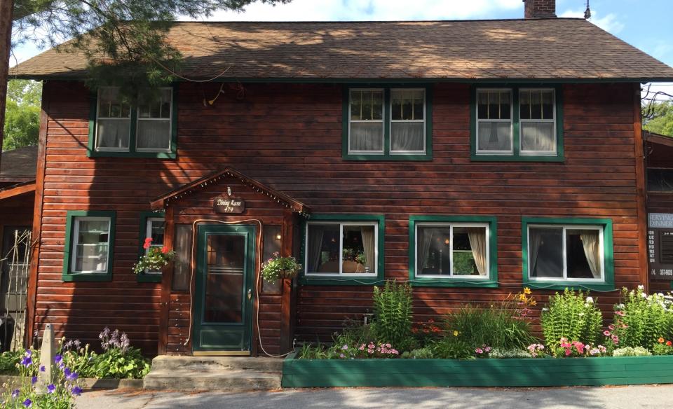 A brown building with green trim.