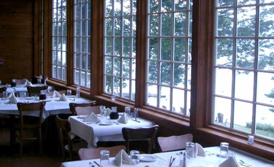 Large windows in the dining room looking out over the snowcovered grounds.