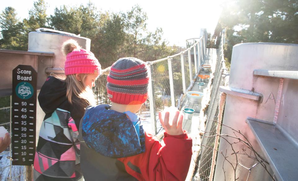 A group of children enter The Wild Walk in the winter