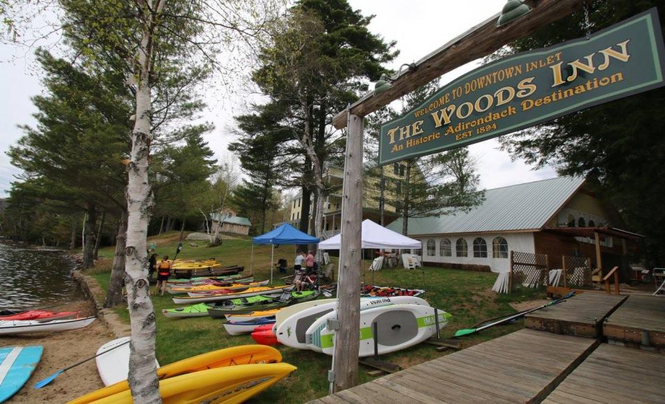 Kayaks and paddle boards stacked and ready for use.