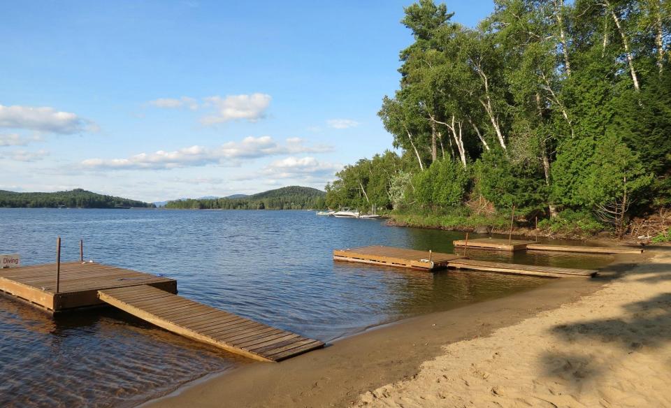 A sandy beach with docks.