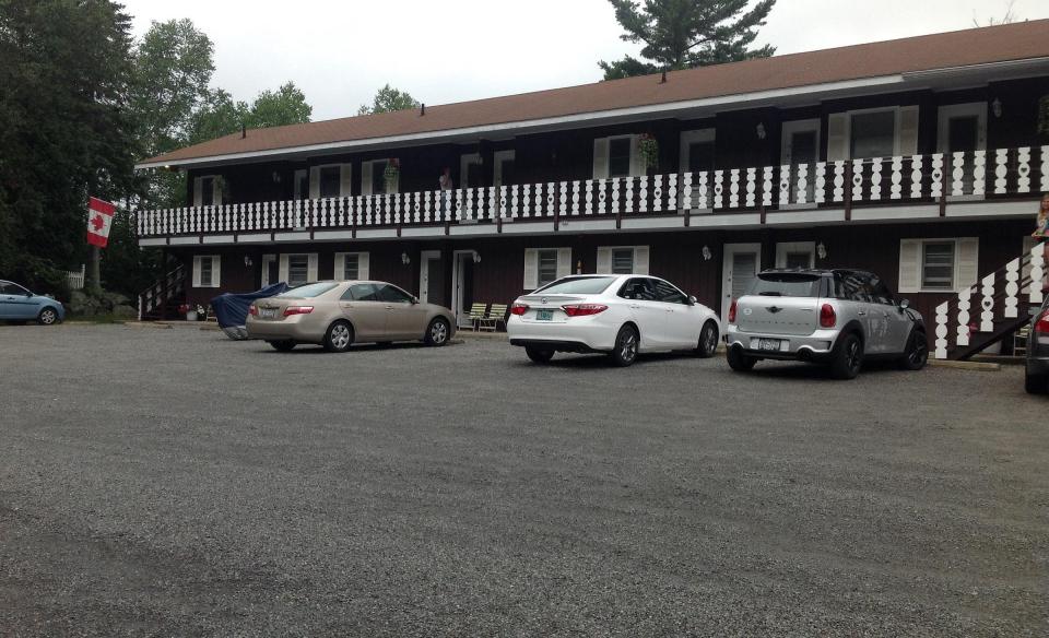 The parking area looking at the rooms and balcony at Sandy Point Motel.