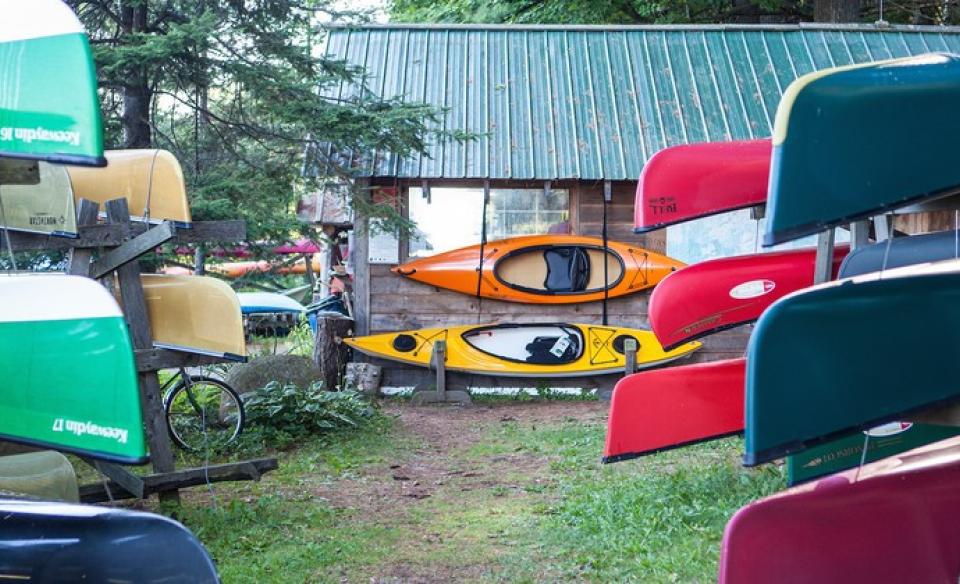 Colorful boats on racks outside.