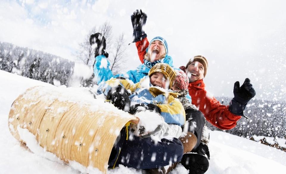 A happy family on a toboggan