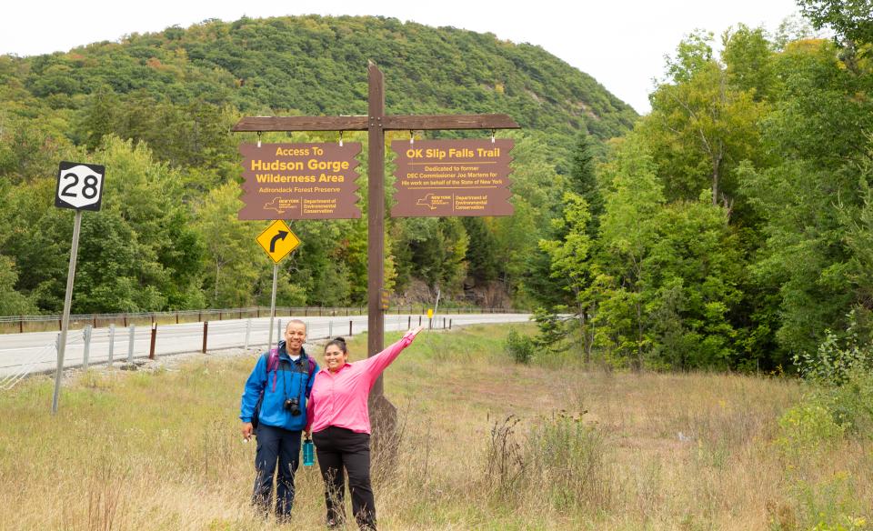A couple poses by the OK Slip Falls trailhead