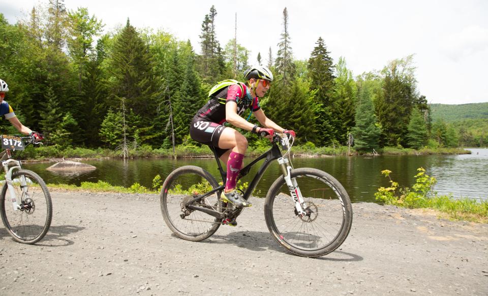 A cyclist on a dirt road by the water
