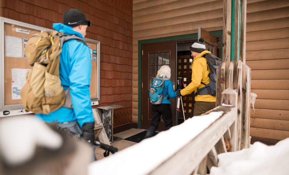 A few people walking into the AIC in the winter