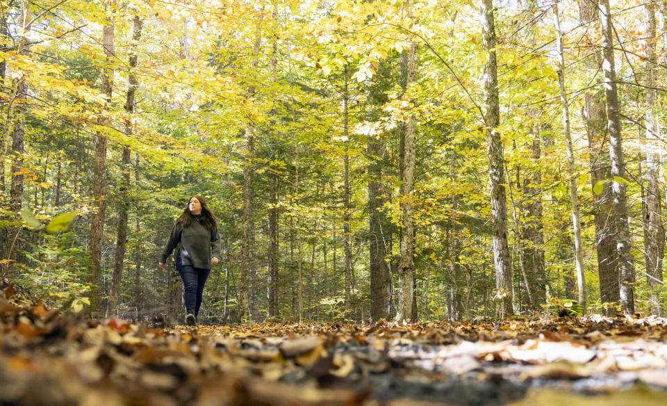 A woman walks on the trail at the AIC.