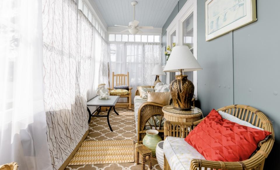 The front walkway up to a landing and the three season room.