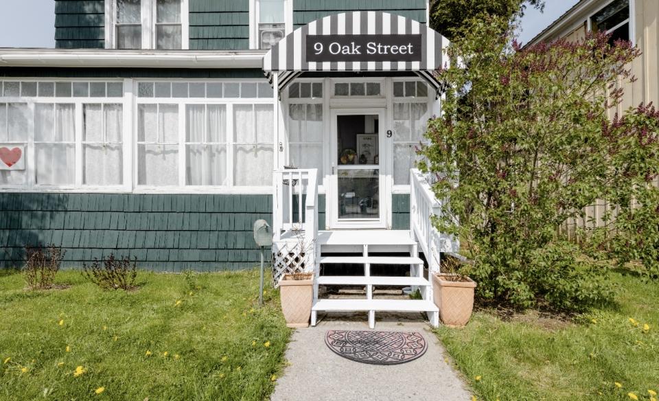The formal dining space with comfy chairs and salmon walls