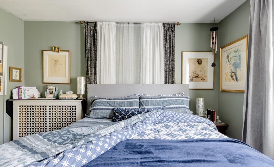 A bright and light three season room with linen curtains and cane furniture.